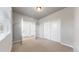 Bright bedroom features neutral carpet, large window, and a closet with sliding doors at 6799 Navajo St, Denver, CO 80221