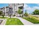 Modern townhome exterior with landscaped yard and sidewalk at 6799 Navajo St, Denver, CO 80221