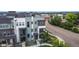 A stylish multi-story home with a front balcony offers modern living, complemented by a lush green landscape at 6799 Navajo St, Denver, CO 80221