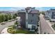 Modern townhome featuring gray facade, upper level deck, and a well-kept landscape at 6799 Navajo St, Denver, CO 80221