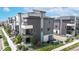 Modern townhome with a blend of gray and white exterior finishes and multiple balconies at 6799 Navajo St, Denver, CO 80221