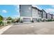 A row of attached garages feature a modern design, providing convenient and secure parking for residents at 6799 Navajo St, Denver, CO 80221