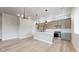 Bright kitchen with stainless steel appliances, quartz countertops, and modern lighting at 6799 Navajo St, Denver, CO 80221