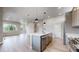 Kitchen with stainless steel appliances, island seating, and open floorplan at 6799 Navajo St, Denver, CO 80221