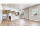 Well-lit kitchen with stainless steel appliances, quartz countertops, and island seating at 6799 Navajo St, Denver, CO 80221
