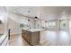 Open floorplan kitchen with stainless steel appliances, island seating, and modern design at 6799 Navajo St, Denver, CO 80221