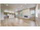 Open concept living area features modern fireplace, wood floors, and lots of natural light at 6799 Navajo St, Denver, CO 80221