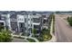 A street view features homes with modern architecture, complemented by sidewalks and lush trees at 6799 Navajo St, Denver, CO 80221
