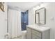 Modern bathroom featuring a tiled shower, updated vanity, and a well-lit mirror for convenience at 6420 W 6Th Ave, Lakewood, CO 80214