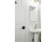 Cozy bathroom showcasing a classic pedestal sink, modern fixtures, and a shower with subway tile surround at 6420 W 6Th Ave, Lakewood, CO 80214