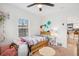 Bright bedroom with whimsical décor, natural light, wood floors, and comfortable atmosphere at 6420 W 6Th Ave, Lakewood, CO 80214