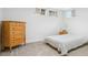 Neutral bedroom featuring carpet, natural light, and a wooden dresser at 6420 W 6Th Ave, Lakewood, CO 80214