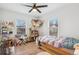 Charming bedroom has bright windows, wood floors, lots of light and plenty of decorative wall decor at 6420 W 6Th Ave, Lakewood, CO 80214