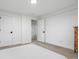 This bedroom has neutral-toned walls and carpet, doors with hardware, and a wooden dresser at 6420 W 6Th Ave, Lakewood, CO 80214