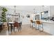 Eat-in kitchen with a dining table adjacent to the island with barstool seating, and stainless appliances at 6420 W 6Th Ave, Lakewood, CO 80214