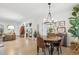 Open dining room featuring hardwood floors, a stylish chandelier, and seamless access to the living area at 6420 W 6Th Ave, Lakewood, CO 80214