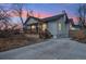 Charming home featuring a quaint front porch, updated siding, and a spacious driveway at 6420 W 6Th Ave, Lakewood, CO 80214