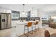 Beautiful open concept kitchen with stainless appliances, eat in breakfast bar, and modern fixtures at 6420 W 6Th Ave, Lakewood, CO 80214