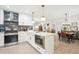Well-designed kitchen with a central island, stainless steel appliances, and stylish finishes, open to the dining room at 6420 W 6Th Ave, Lakewood, CO 80214