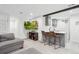 Cozy living space with bar seating, comfortable gray sectional sofa, and a modern entertainment setup at 6420 W 6Th Ave, Lakewood, CO 80214
