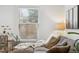 A cozy corner provides a peaceful sitting area with a comfortable couch and plants with natural sunlight at 6420 W 6Th Ave, Lakewood, CO 80214