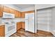 The kitchen features wood cabinets, a white fridge, and a white microwave and oven at 9126 Gale Blvd # 2, Thornton, CO 80260