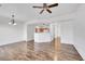 Open-concept living room showcasing wood flooring and views to the kitchen area at 9126 Gale Blvd # 2, Thornton, CO 80260