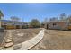 Large backyard with a stone path leading to a detached two-car garage at 6488 E 63Rd Pl, Commerce City, CO 80022