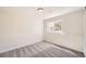 An empty bedroom featuring carpet flooring, a window, and neutral colored walls at 6488 E 63Rd Pl, Commerce City, CO 80022