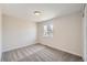 An empty bedroom with carpet flooring, a window with natural light and neutral paint color at 6488 E 63Rd Pl, Commerce City, CO 80022
