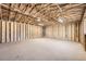 Unfinished garage with exposed ceiling beams ready to be customized at 6488 E 63Rd Pl, Commerce City, CO 80022