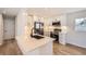 Modern kitchen with white cabinets, stainless steel appliances, and an island at 6488 E 63Rd Pl, Commerce City, CO 80022