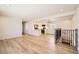 Spacious living room with open layout, light floors, and stairway access at 6488 E 63Rd Pl, Commerce City, CO 80022