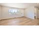 Inviting living area featuring light flooring and a large window at 6488 E 63Rd Pl, Commerce City, CO 80022
