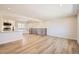 Bright, open-concept living area with modern flooring and a kitchen view at 6488 E 63Rd Pl, Commerce City, CO 80022