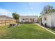 Expansive backyard featuring a lawn, covered patio, fence, and firepit seating at 1749 Havana St, Aurora, CO 80010