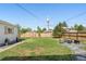 Spacious backyard with lush lawn, wooden fence, and a cozy fire pit area at 1749 Havana St, Aurora, CO 80010