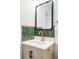 Stylish bathroom vanity with green tile backsplash, modern fixtures, and a framed mirror at 1749 Havana St, Aurora, CO 80010