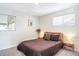 Bright bedroom with a wooden bed frame, cozy bedding, and minimalist decor, creating a serene retreat at 1749 Havana St, Aurora, CO 80010