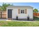 Detached garage with a modern door, window with decorative shutters, and stylish planters at 1749 Havana St, Aurora, CO 80010