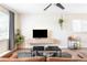 Well-lit living room with modern furniture, sleek floating media console, and stylish gray rug at 1749 Havana St, Aurora, CO 80010