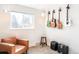 Inviting music room with window light, guitars, and a comfortable leather chair at 1749 Havana St, Aurora, CO 80010