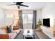 Bright living room with a cozy brown couch, chic black coffee table, and contemporary decor at 1749 Havana St, Aurora, CO 80010
