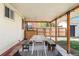 Charming covered outdoor patio with a large table, benches, and string lights at 1749 Havana St, Aurora, CO 80010