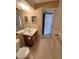 Bright bathroom with single sink vanity, tile floors, and modern fixtures at 4400 S Quebec St # C107, Denver, CO 80237