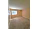 Neutral bedroom with plush carpet, bright natural light, and closet for storage at 4400 S Quebec St # C107, Denver, CO 80237