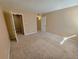 Large bedroom with tan walls, neutral carpet and closet with a partial view of the en suite at 4400 S Quebec St # C107, Denver, CO 80237