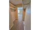 Walk-in closet with built-in shelving, neutral carpet and a partial view to the bedroom at 4400 S Quebec St # C107, Denver, CO 80237