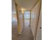 Hallway with large storage closet, leading to a bedroom in neutral colors at 4400 S Quebec St # C107, Denver, CO 80237