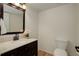 Bathroom featuring a decorative mirror and single sink vanity on wood floor at 4605 S Yosemite St # 39, Denver, CO 80237